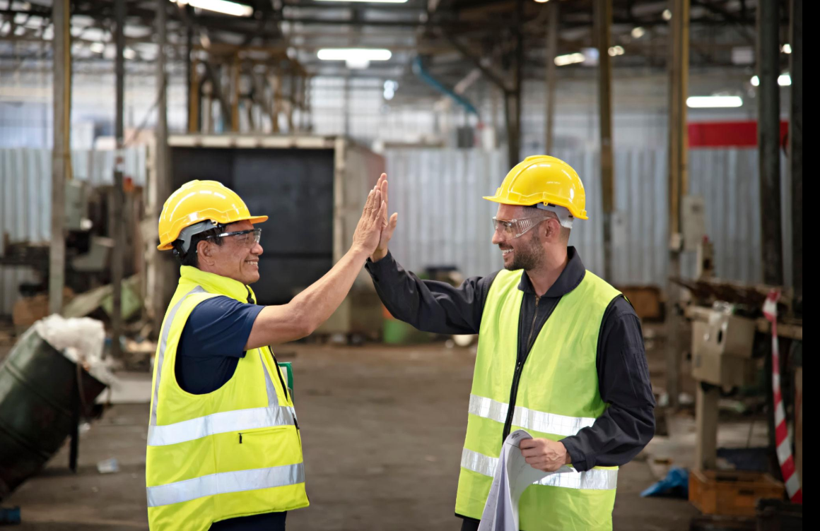 New Heights Languages employees — a diverse group of manufacturing workers with their instructor